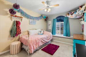 Bedroom with ceiling fan and carpet floors