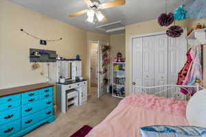 Carpeted bedroom featuring a closet and ceiling fan