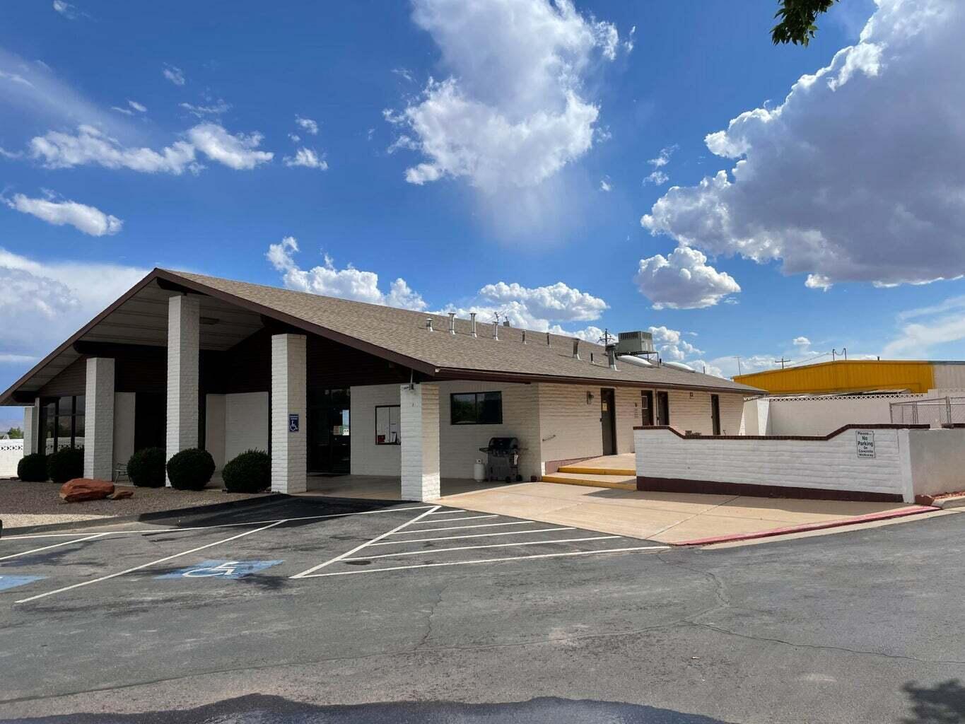 View of property featuring uncovered parking