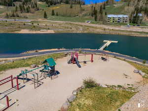 Birds eye view of property with a water view