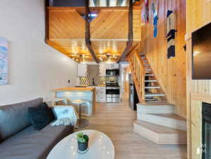 Living room featuring wood ceiling and light hardwood / wood-style flooring