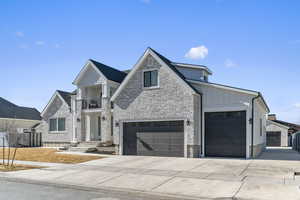 View of front facade featuring a mountain view and a detached garage