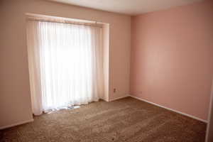 Carpeted spare room with a textured ceiling