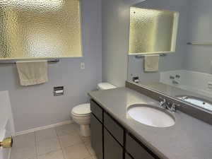 Bathroom with tile patterned flooring, vanity, and toilet