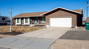 Ranch-style house featuring a garage and covered porch