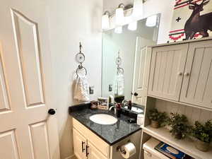 Bathroom with vanity, tile patterned floors, toilet, and a textured ceiling