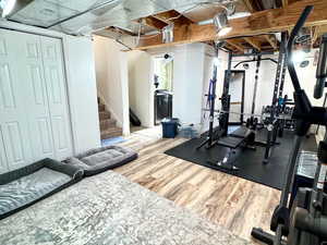 Exercise room featuring hardwood / wood-style floors