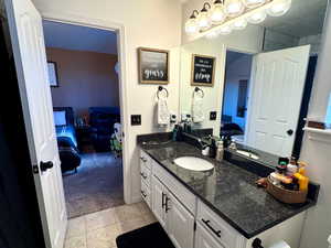 Bathroom with tile patterned flooring, vanity, a textured ceiling, and toilet