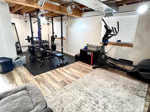 Exercise area with hardwood / wood-style flooring