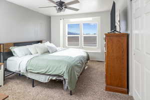 Carpeted bedroom with ceiling fan