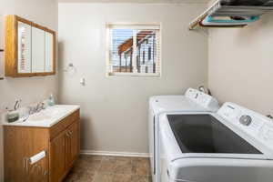 Laundry area featuring sink and washing machine and dryer