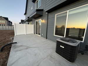 Patio terrace at dusk featuring central AC