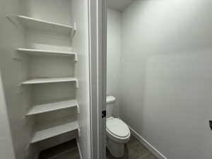 Bathroom featuring wood-type flooring and toilet