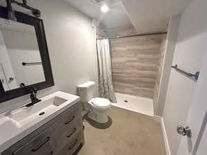 Bathroom with vanity, toilet, and a shower with shower curtain