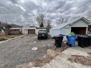 View of side of property featuring a garage and an outdoor structure