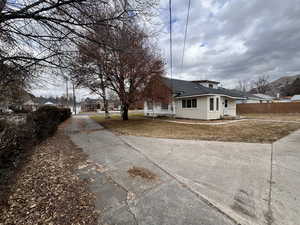 View of side of home featuring a lawn