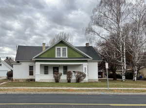 View of front of house featuring a front yard and covered porch