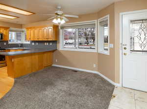 Kitchen with ceiling fan, stainless steel appliances, and kitchen peninsula