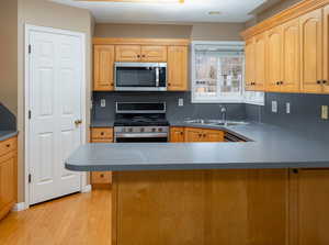 Kitchen featuring sink, light hardwood / wood-style flooring, stainless steel appliances, and light brown cabinets