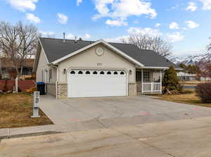 View of front of house with a porch and a garage