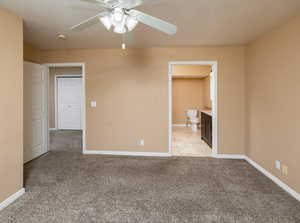 Carpeted empty room featuring ceiling fan