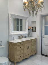 Bathroom with marble vanity and toilet