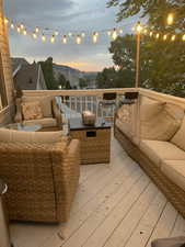 Deck at dusk featuring an outdoor living space and mountain views.