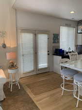 Kitchen with center eat in island, featuring hard wood flooring.