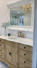 Bathroom featuring vanity with marble