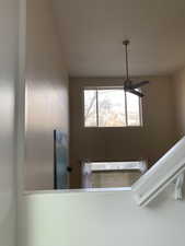 Staircase featuring ceiling fan.