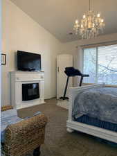 Bedroom featuring dark carpet and vaulted ceiling.