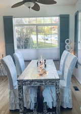 Dining area with hard wood flooring and ceiling fan.