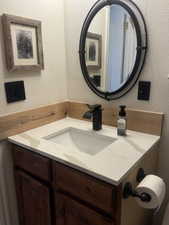 Bathroom with knotty alder cabinet & backsplash, vanity with quartz