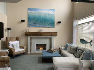 Living room with a glass tiled fireplace.  Blue fire glass.