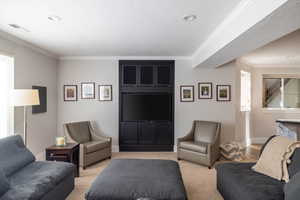 Carpeted living room featuring crown molding and a textured ceiling