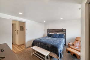 Bedroom featuring a textured ceiling and light wood-type flooring