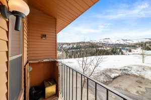 Snow covered back of property featuring a mountain view