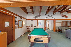 Game room featuring pool table, carpet floors, and beamed ceiling