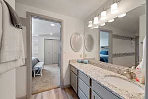 Bathroom with vanity and wood-type flooring