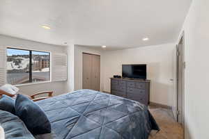 Bedroom featuring a closet, carpet, and a textured ceiling