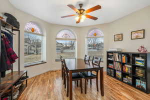 Dining area with light hardwood / wood-style flooring and ceiling fan