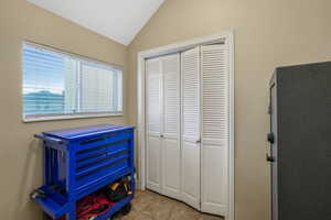 Bedroom featuring vaulted ceiling and a closet