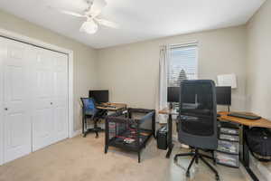 Carpeted office space with ceiling fan