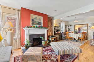 Living room with hardwood / wood-style flooring and a tile fireplace