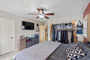 Carpeted bedroom featuring a closet and ceiling fan