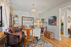 Dining area with wood-type flooring