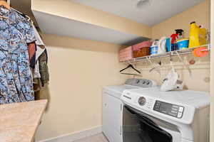 Clothes washing area featuring washing machine and dryer