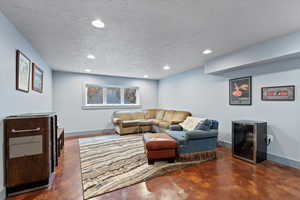 Living room with wine cooler and a textured ceiling