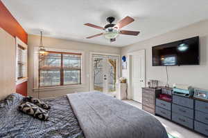 Bedroom with ceiling fan, access to exterior, a textured ceiling, light carpet, and french doors