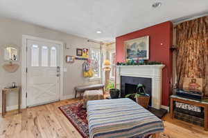 Sitting room featuring a fireplace and light hardwood / wood-style flooring